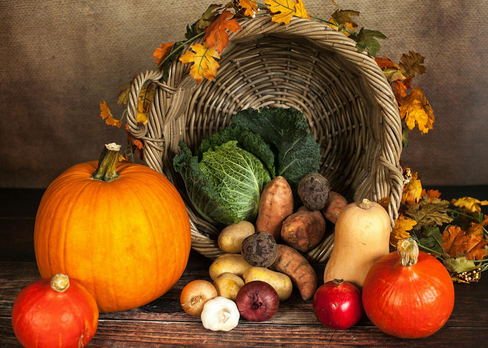 A rustic cornucopia overflowing with fresh autumn vegetables, symbolizing abundance and harvest.